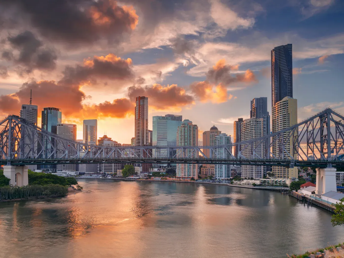 Brisbane city skyline and the Story Bridge at sunset over the river