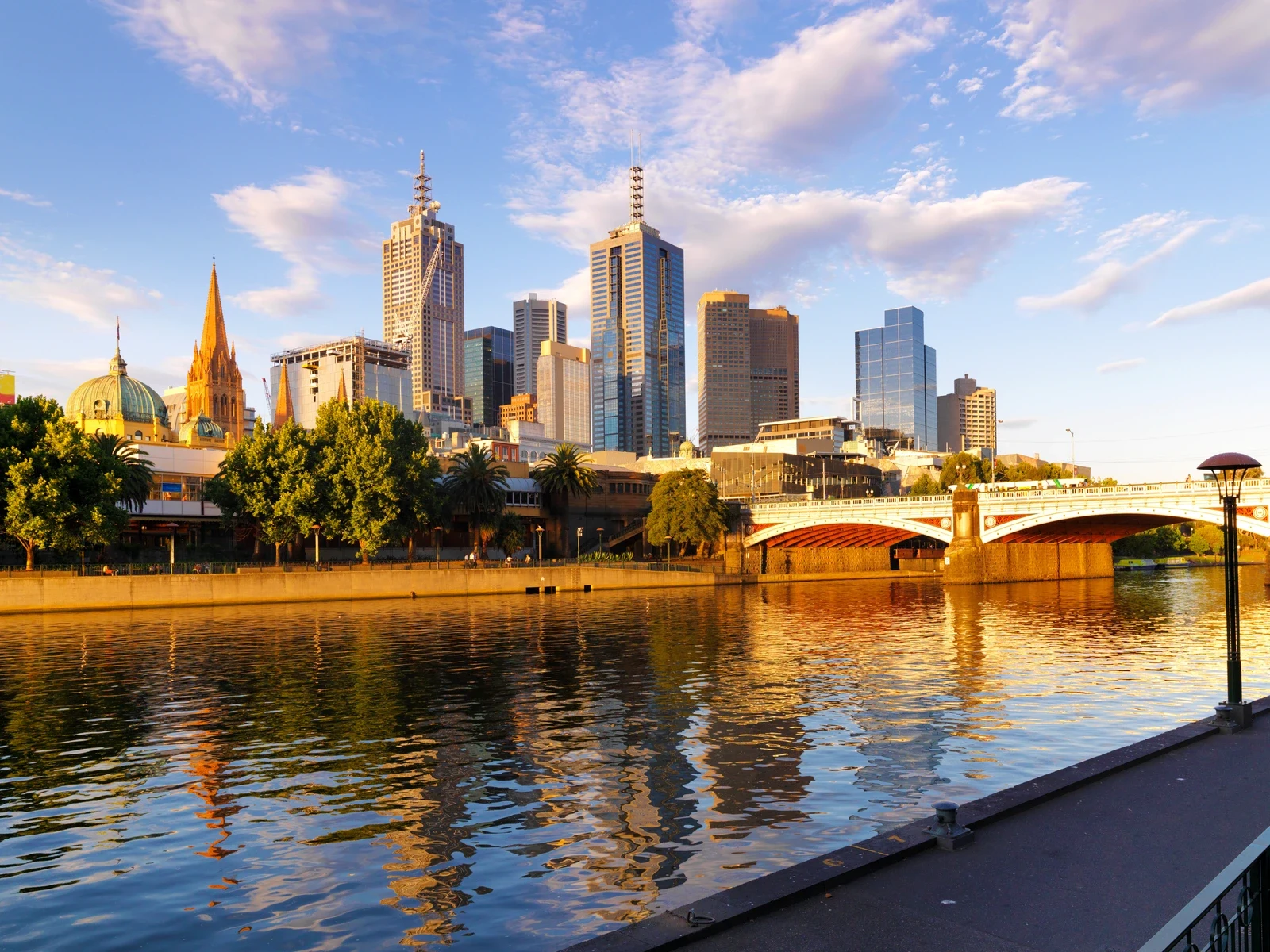 Melbourne city skyline at sunset reflected in the Yarra River